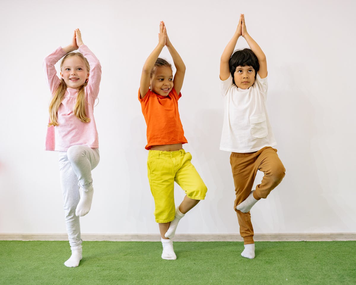 Children practicing yoga tree pose